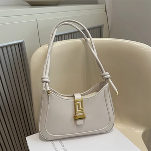 Minimalist cream white crescent underarm bag with gold geometric buckle and knotted straps