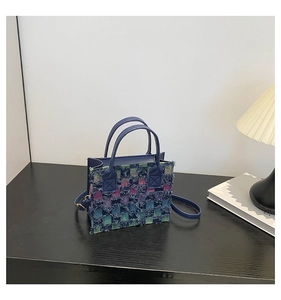 Detail of blue and purple plaid texture with fringe on stylish square tote bag