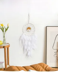 Detail showing white dreamcatcher with soft feathers and tree of life bead ornament