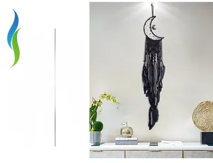 Detailed view of black moon dreamcatcher with handmade macrame fringe and soft feathers