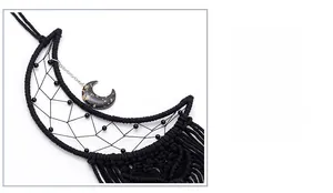 Detail of handcrafted black cotton weave and moon resin ornament for wall decor