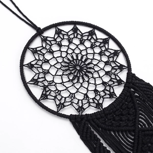 Handmade black macrame dream catcher wall hanging with intricate bohemian weaving patterns