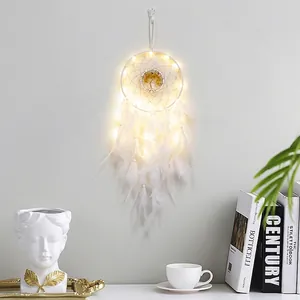 Handmade dream catcher with white feathers and warm LED lights for wall decoration