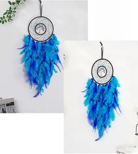 Detail of handmade Tree of Life dreamcatcher with blue feathers and crystal beads