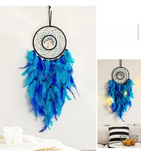 Detail of bohemian dream catcher with blue feathers and tree of life wire weaving