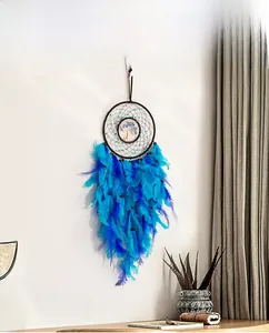 Detail of handmade Tree of Life dream catcher with blue stones and gradient feathers