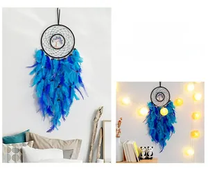 Detail of dream catcher with blue feathers and tree of life weaving for home decor