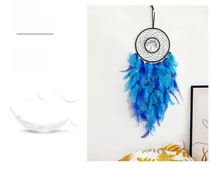 Detail of blue dream catcher with feathers, tree of life, and blue beads in home setting