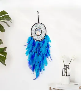 Detail of dream catcher with Tree of Life wire weaving and blue gradient feathers