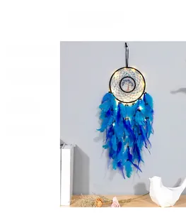Detail of blue dream catcher with tree of life weaving and warm LED light hanging on wall