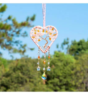 Detail of tree of life heart pendant with pink crystal chips and rainbow teardrop charm
