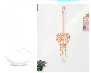 Detail of pink heart dreamcatcher with golden tree of life and crystal drop charms