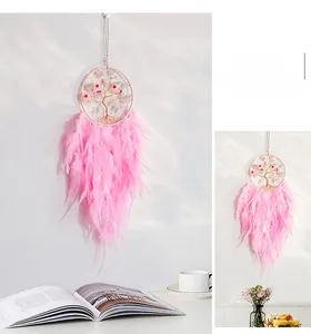 Detailed view of handmade pink feather dream catcher with Tree of Life wire weaving