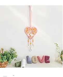 Detail of handmade Tree of Life pink crystal dreamcatcher with heart-shaped weaving
