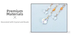 Detailed view of faceted crystal star and iridescent teardrop pendant on gold chain