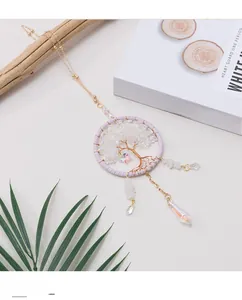Close-up of a handmade crystal tree of life dreamcatcher hanging with purple woven ring