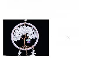 Detailed view of hand-woven tree of life moon pendant with white crystal chips and star