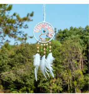 Detail of blue dream catcher with tree of life design and feathers for car decor