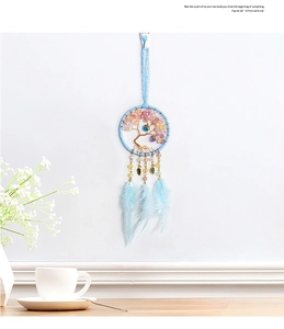 Close-up of tree of life dreamcatcher with blue feathers and colorful beads