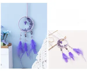 Detail of bohemian purple dream catcher with moon stones and elegant feathers