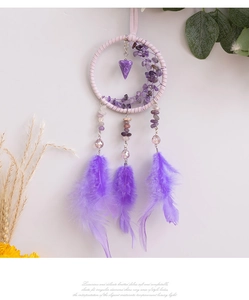 Detailed shot of a purple bohemian dreamcatcher car charm with feathers and moon stone