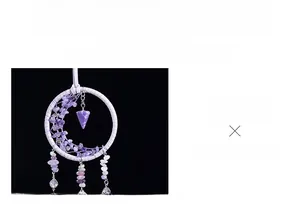 Detail of a purple dreamcatcher car pendant with woven ring and crystal stone tassels