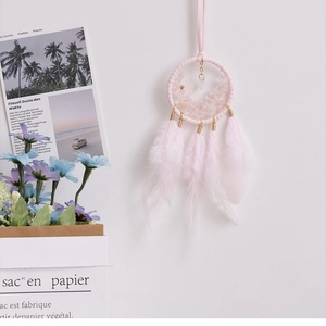 Pink dreamcatcher car interior hanging with natural feathers and rose quartz stones