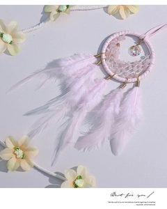 Detailed view of pink rose quartz dreamcatcher with fluffy feathers and beads