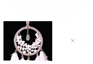 Macro shot of pink dreamcatcher car pendant with woven ring, crystals and soft feathers