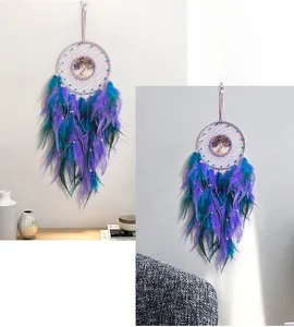Detail of Tree of Life dream catcher with purple feathers and turquoise beads decor