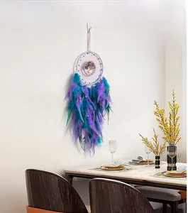 Detail of a white Tree of Life dream catcher with purple and blue gradient feathers