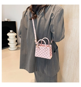 Pink monogram mini crossbody bag styled with a grey blazer for a modern fashion look