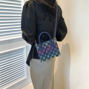 Chic tweed woven crossbody bag in colorful fabric with fringe and leather handles