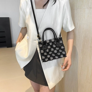 Fashionable black and white checkered crossbody bag with texture fringe and leather strap