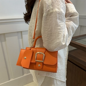 Vibrant orange square crossbody bag in litchi grain faux leather with gold buckle detail