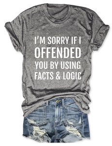Flat lay of gray cotton T-shirt with logic slogan and ripped denim shorts for summer