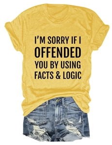 Flat lay of yellow t-shirt with slogan and distressed denim shorts with ripped details
