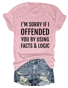 Close-up of pink t-shirt with I'm Sorry If I Offended You graphic and denim shorts