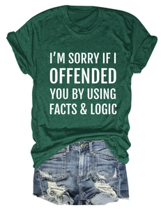 Flat lay of dark green T-shirt with white slogan and distressed denim shorts