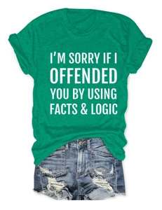 Flat lay of green cotton t-shirt with slogan and distressed blue denim shorts set