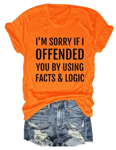 Flat lay of an orange crew neck T-shirt with black slogan print and denim shorts