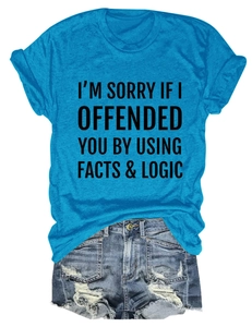 Detail of blue slogan T-shirt with denim shorts featuring distressed holes and frayed hems