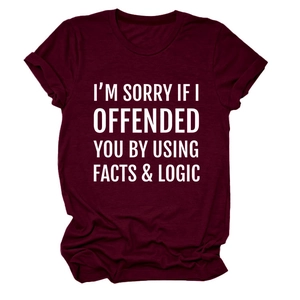 Detail of soft maroon cotton fabric with facts and logic quote print and rolled sleeves
