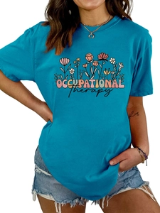 Détail du t-shirt femme bleu sarcelle avec imprimé floral coloré et texte d'ergothérapie