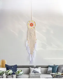 Detailed view of Nordic macrame wall hanging with white feathers and wooden beads