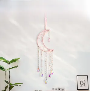 Detailed pink moon dreamcatcher wall hanging with crystal beads in a modern home interior