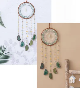 Detail of dreamcatcher wall hanging with green agate slices and natural raw stones
