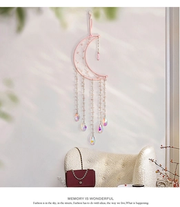 Detail of pink crystal crescent dream catcher with hanging gemstones and teardrop pendants