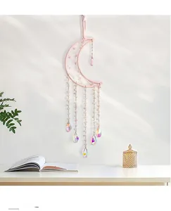 Detail of pink crystal moon dreamcatcher with handmade tree of life and bead chains