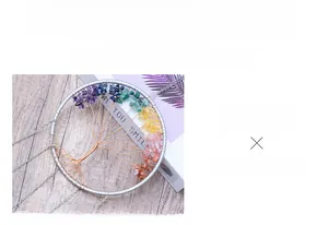 Handcrafted Tree of Life ornament with colorful crystals on polished agate slice